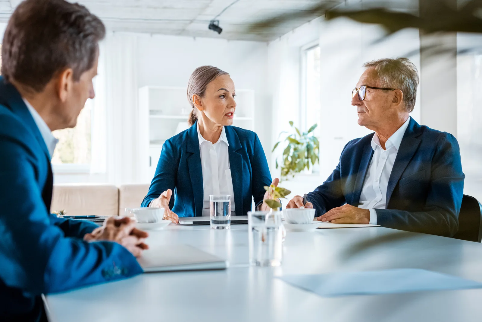 Attorneys and clients participating in a facilitated dispute-resolution meeting around a conference table